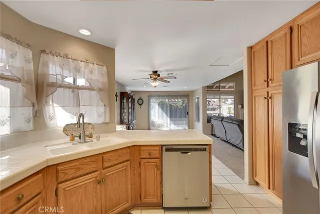a bathroom with a granite countertop sink mirror and cabinets