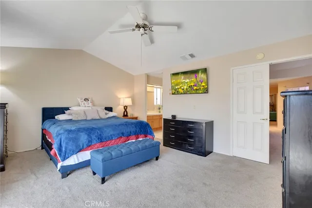 a bedroom with a bed and a ceiling fan