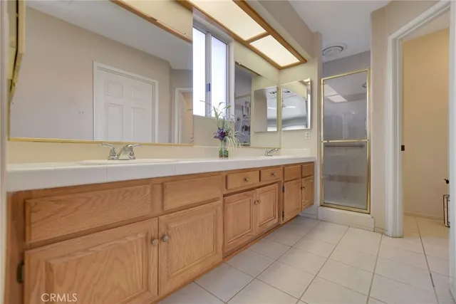 a spacious bathroom with a granite countertop sink a mirror and a
