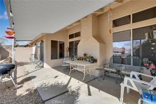 a building outdoor space with patio furniture and potted plants