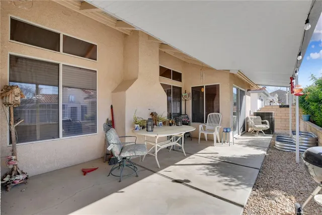 a view of a patio with table and chairs and potted plants