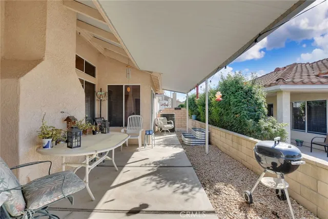 a view of a patio with couches table and chairs and potted plants