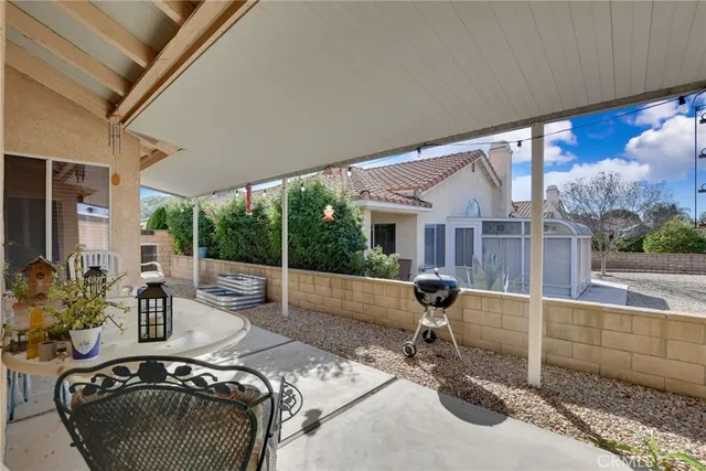a view of a porch with furniture and a yard