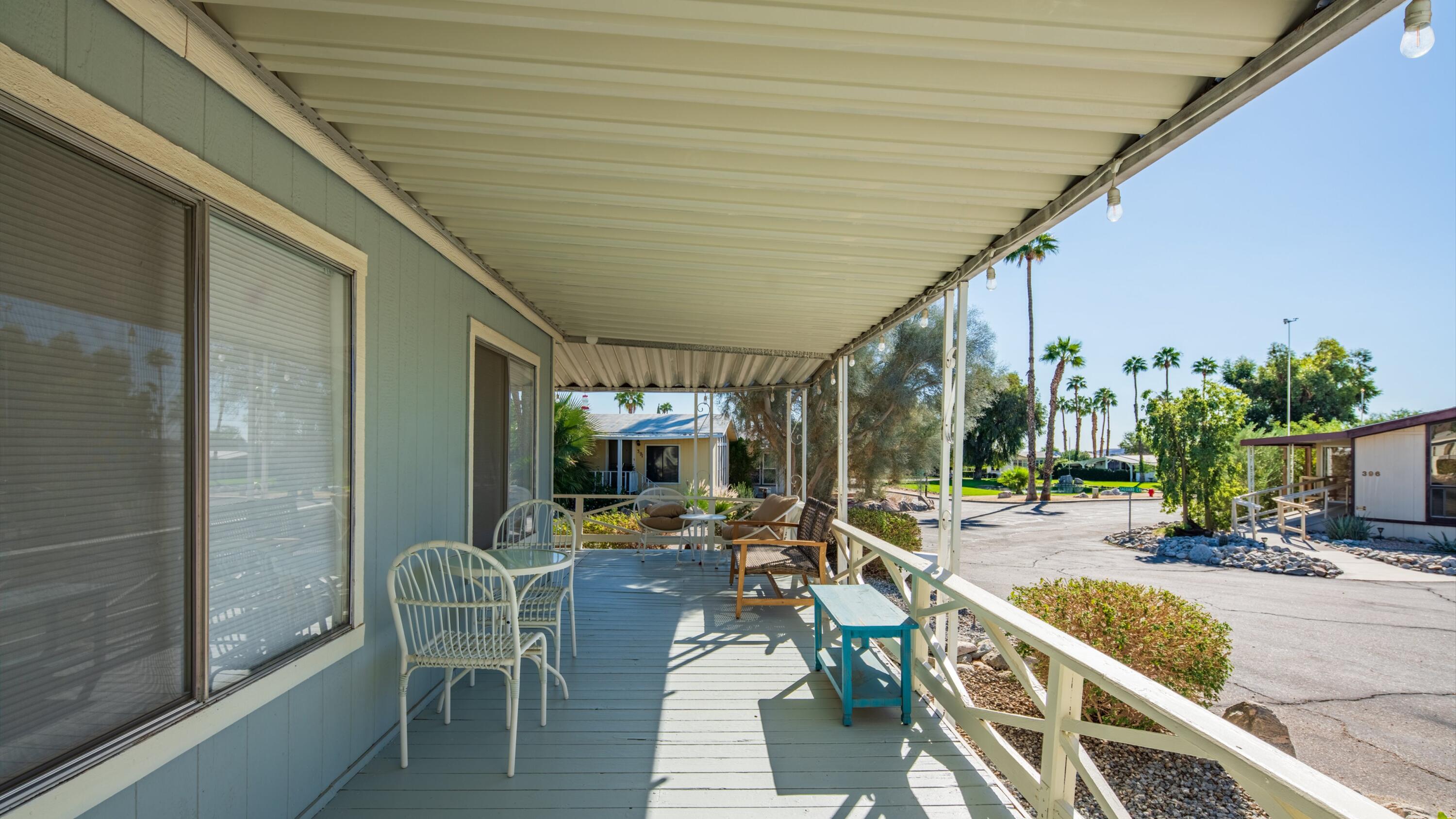 74711 Dillon Road, Unit 392 Desert Hot Springs, CA 92241 - Photo 32 of 46 a outdoor space with lots of chairs and chandelier