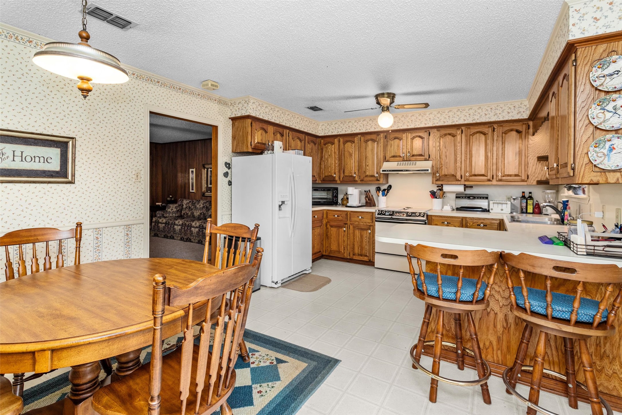 3219 Fm 1817 Elkhart, TX 75839 - Photo 14 of 31 a kitchen with stainless steel appliances kitchen island granite countertop a dining table chairs and a refrigerator