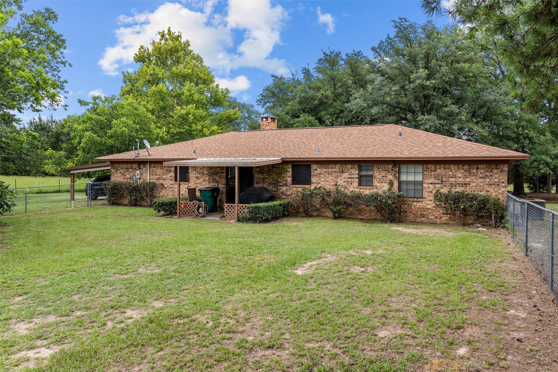 3219 Fm 1817 Elkhart, TX 75839 - Photo 5 of 31 a front view of a house with a garden