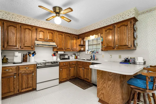 a kitchen with a sink cabinets and window