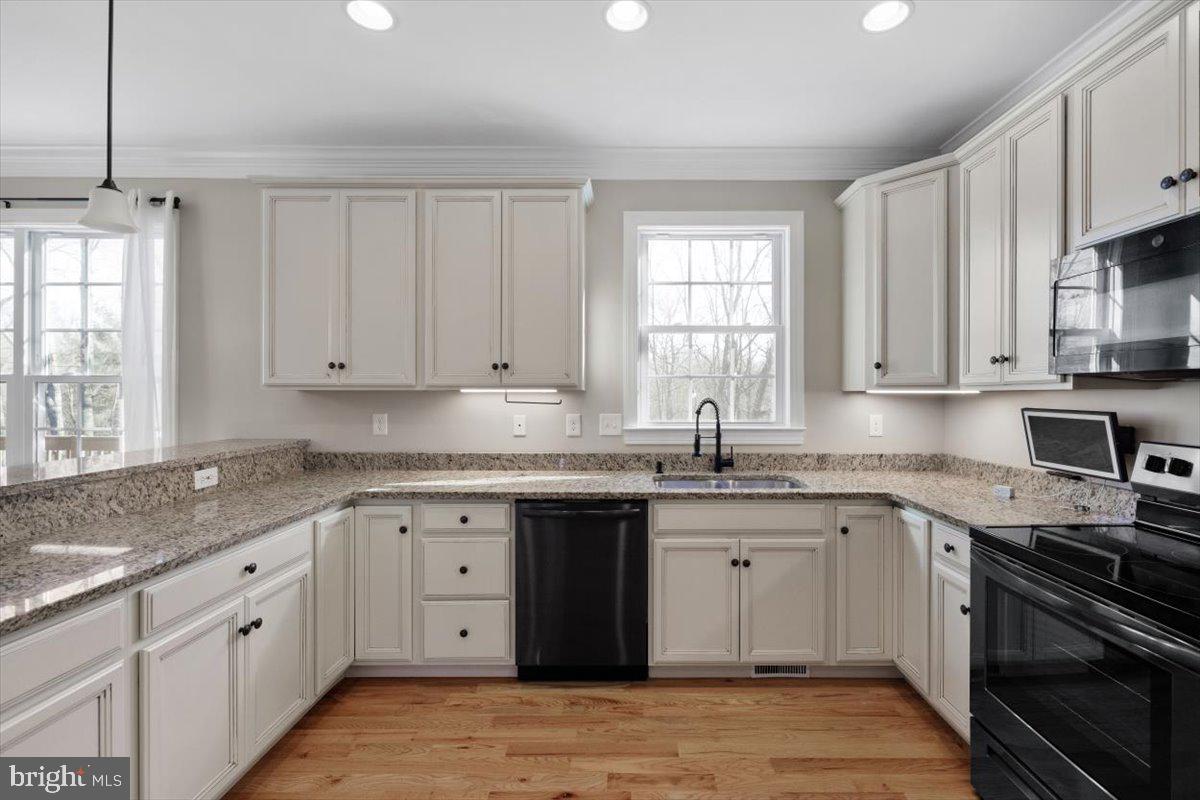 441 Shady Creek Road Clear Brook, VA 22624 - Photo 15 of 46 a kitchen with granite countertop cabinets stainless steel appliances a sink and a window