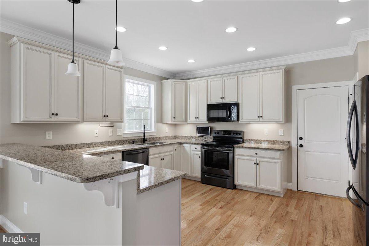 441 Shady Creek Road Clear Brook, VA 22624 - Photo 17 of 46 a kitchen with stainless steel appliances granite countertop a stove a sink and a refrigerator