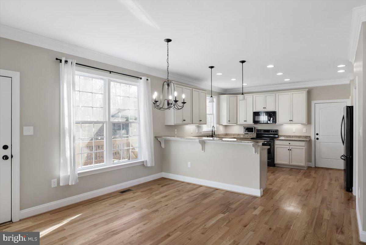 441 Shady Creek Road Clear Brook, VA 22624 - Photo 18 of 46 a kitchen with refrigerator cabinets and wooden floor