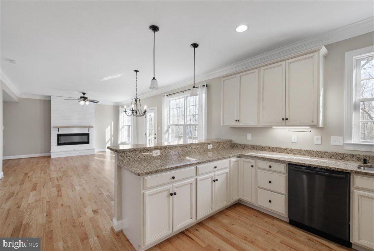 441 Shady Creek Road Clear Brook, VA 22624 - Photo 22 of 46 a kitchen with stainless steel appliances granite countertop a sink a stove and white cabinets with wooden floor
