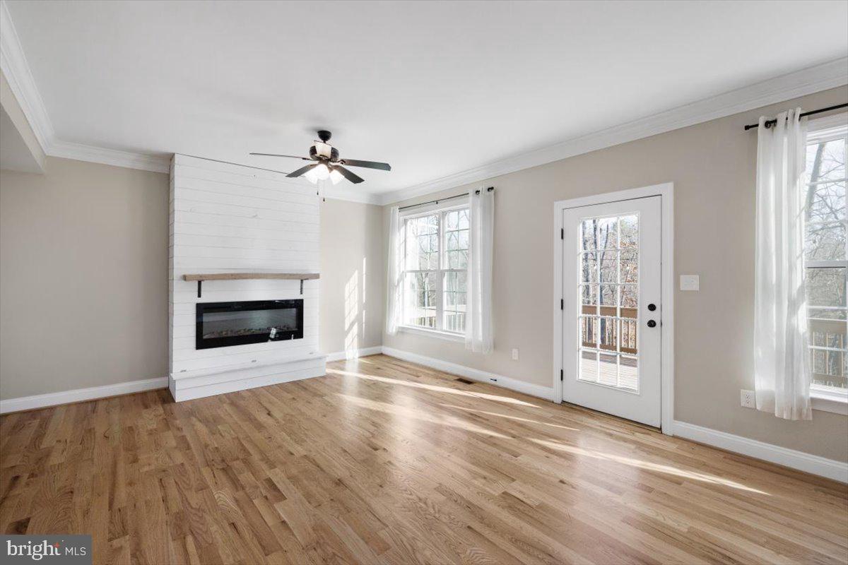 441 Shady Creek Road Clear Brook, VA 22624 - Photo 23 of 46 an empty room with wooden floor fan and windows
