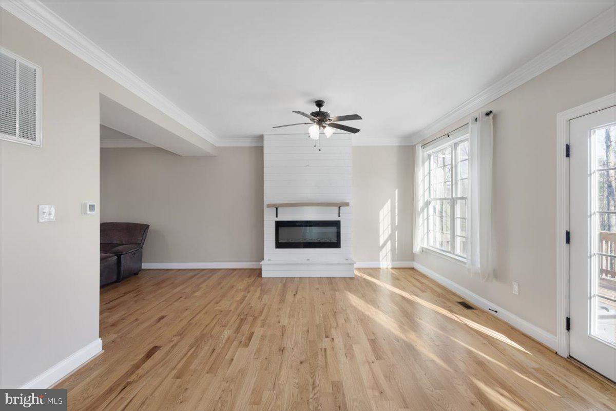 441 Shady Creek Road Clear Brook, VA 22624 - Photo 24 of 46 a view of an empty room with a fireplace and a window