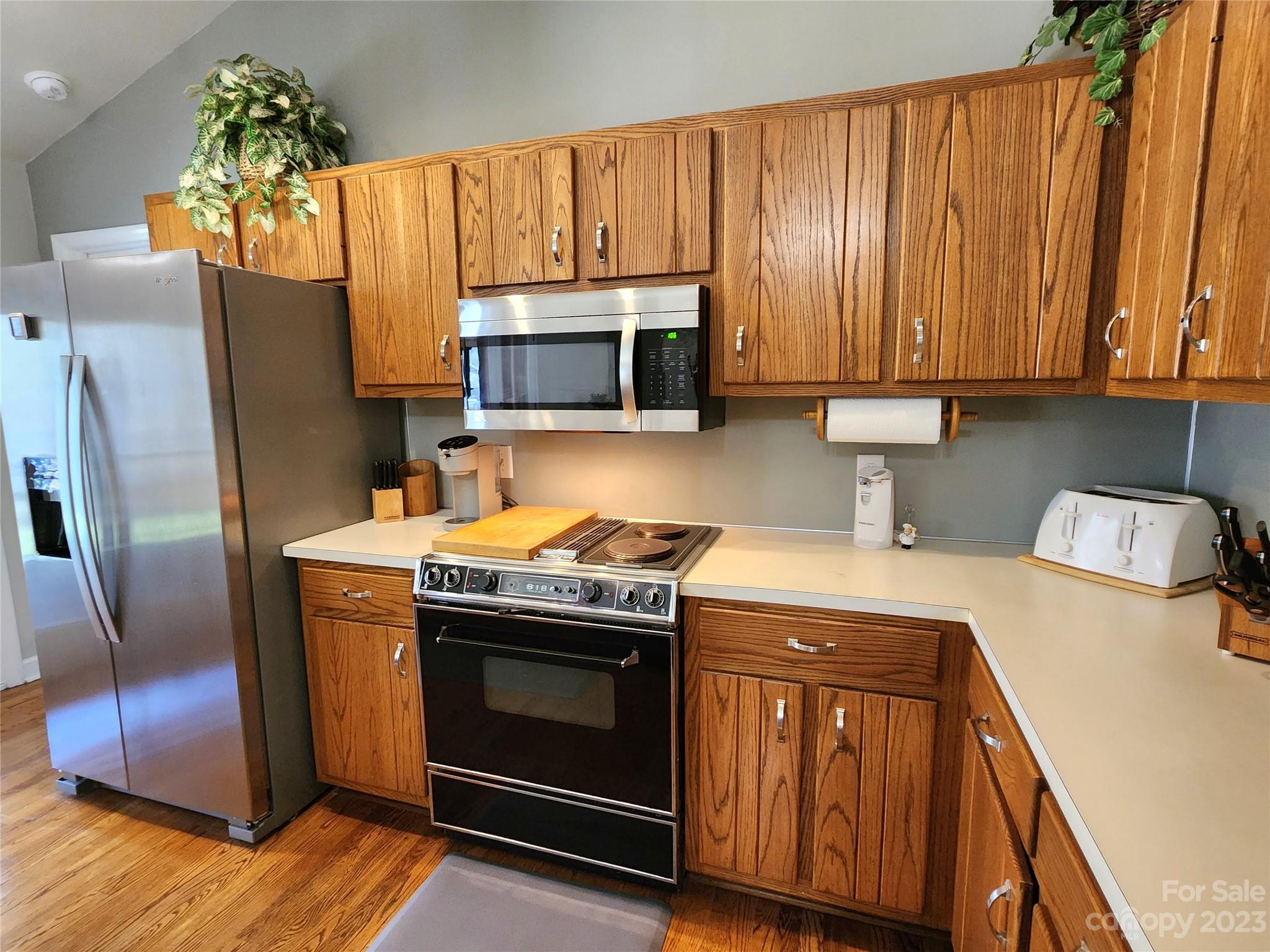 1101 Running Brook Road Midland, NC 28107 - Photo 12 of 48 a kitchen with granite countertop wooden cabinets stainless steel appliances and a counter space
