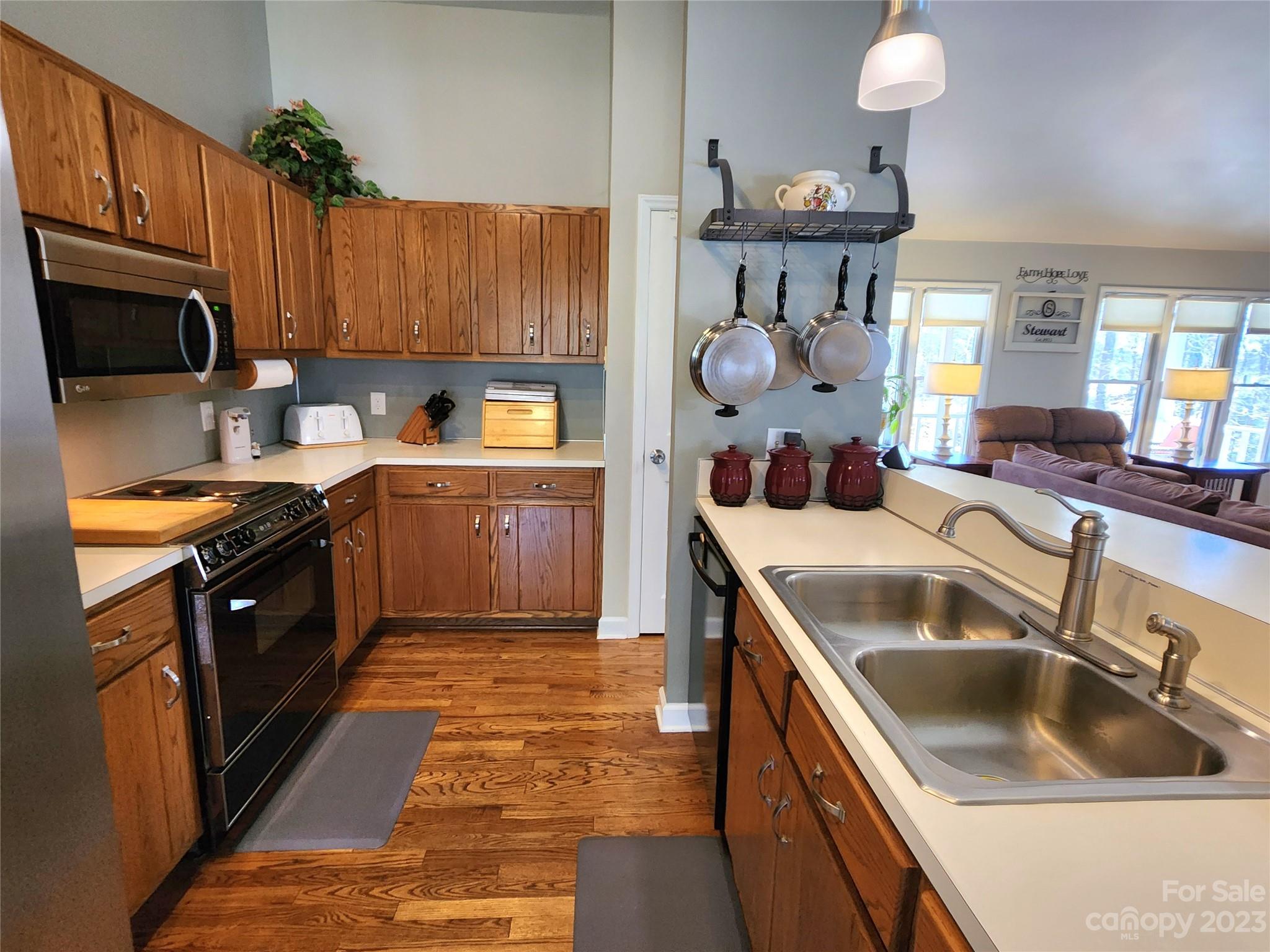 1101 Running Brook Road Midland, NC 28107 - Photo 13 of 48 a kitchen with wooden cabinets a sink and a stove