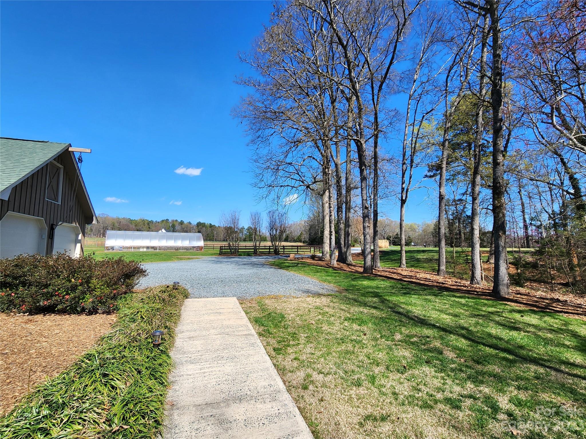 1101 Running Brook Road Midland, NC 28107 - Photo 3 of 48 a view of a swimming pool with a patio and a yard