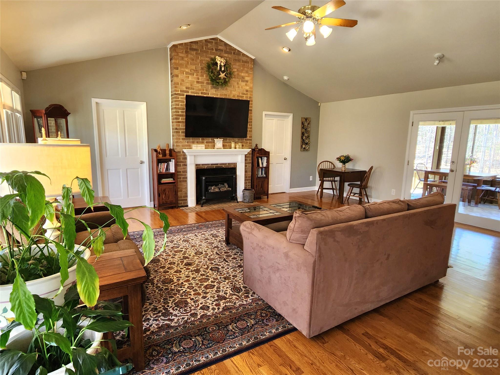 1101 Running Brook Road Midland, NC 28107 - Photo 7 of 48 a living room with furniture a flat screen tv and a fireplace