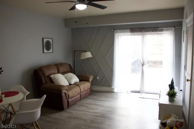 a living room with furniture and a potted plant