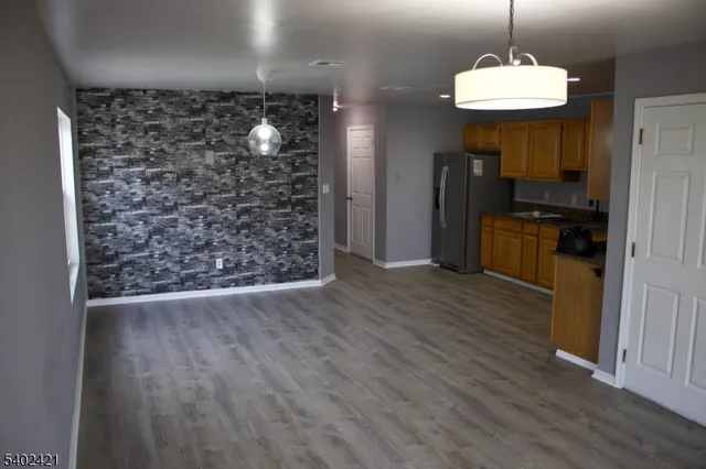 a room with wooden floor a chandelier