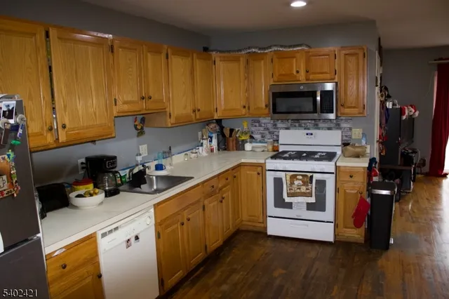 a kitchen with cabinets a sink and appliances