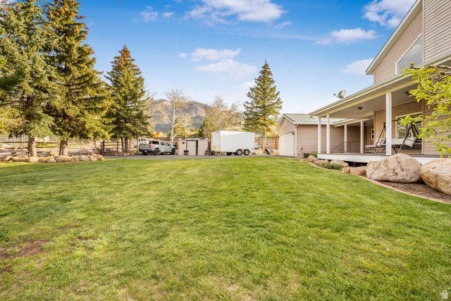 48 South Sage Road Pine Valley, UT 84781 - Photo 53 of 61 Expansive green lawn with mature evergreen trees and a decorative rock border
