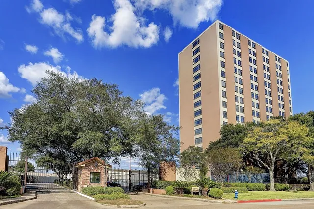 a view of a city street lined with buildings and trees