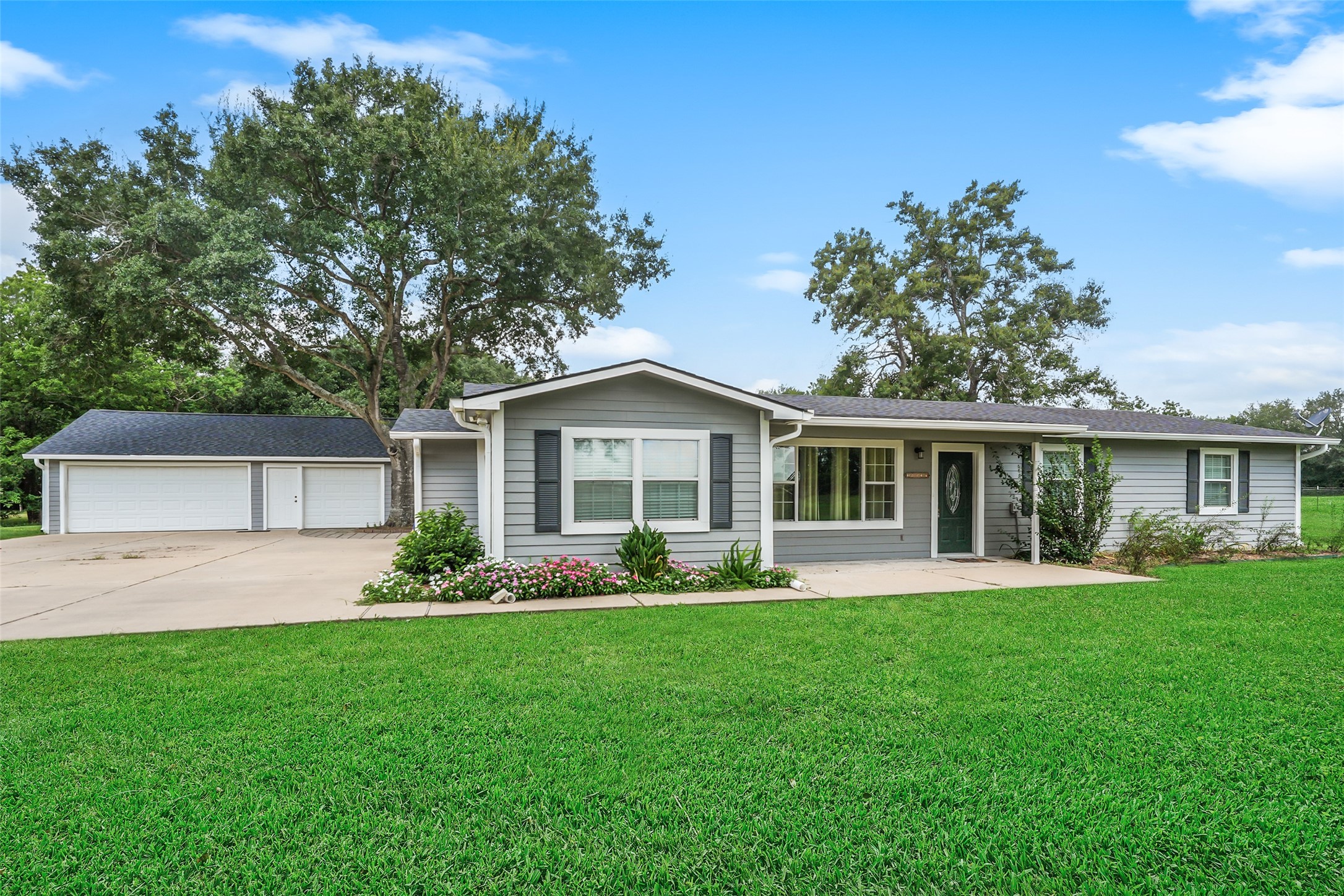 19635 Kermier Road Waller, TX 77484 - Photo 6 of 27 Attached two-car garage and expansive front yard offer convenience and curb appeal.