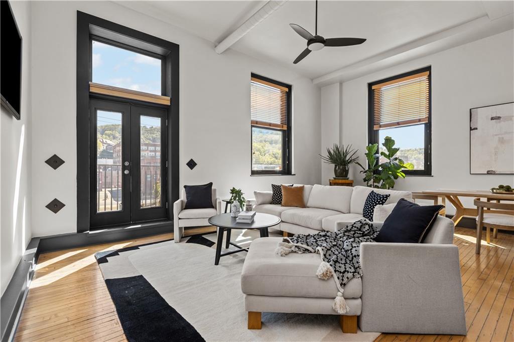 3080 Smallman Street, Unit 8 Pittsburgh, PA 15201 - Photo 13 of 39 a living room with furniture two windows and a potted plant