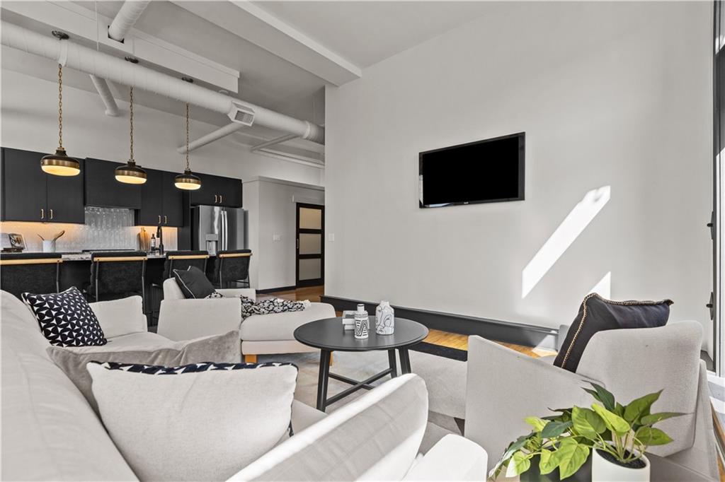 3080 Smallman Street, Unit 8 Pittsburgh, PA 15201 - Photo 20 of 39 a living room with furniture and a flat screen tv