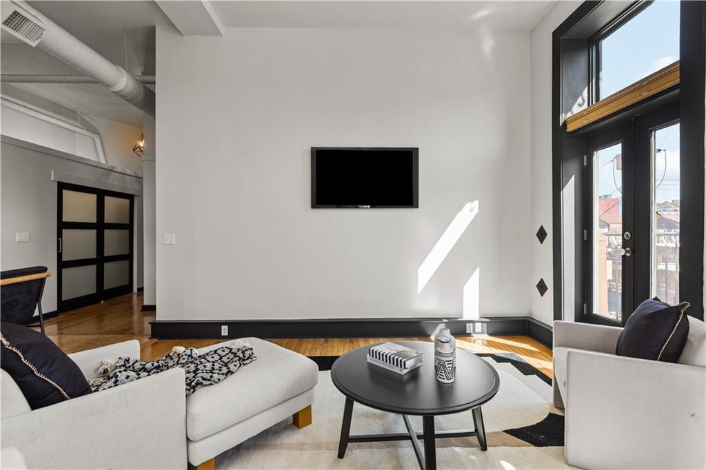 3080 Smallman Street, Unit 8 Pittsburgh, PA 15201 - Photo 21 of 39 a living room with furniture and a flat screen tv