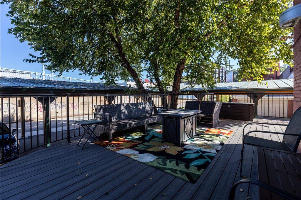 3080 Smallman Street, Unit 8 Pittsburgh, PA 15201 - Photo 31 of 39 a view of deck with table and chairs couches and wooden floor