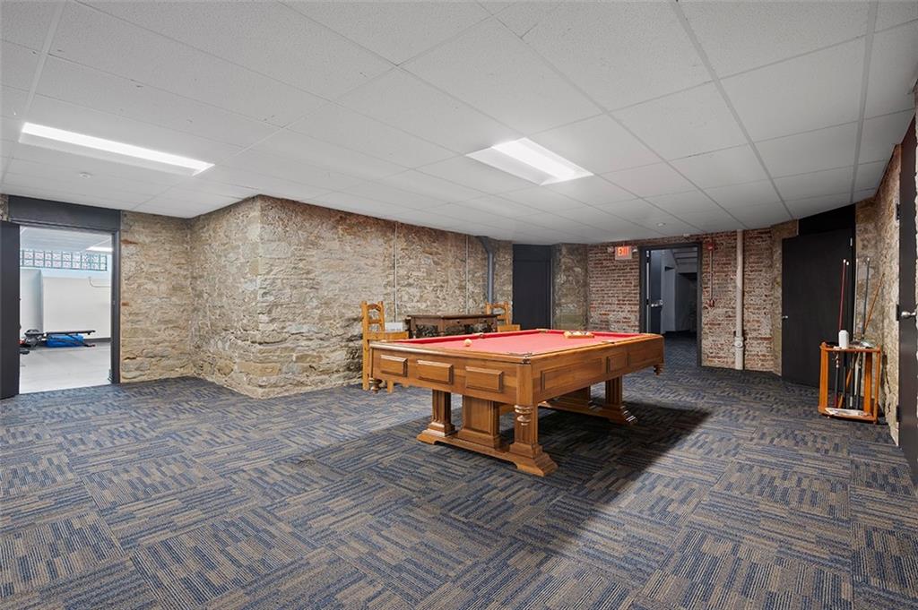 3080 Smallman Street, Unit 8 Pittsburgh, PA 15201 - Photo 35 of 39 a spacious bedroom with a bed and a table