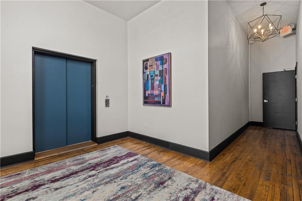 3080 Smallman Street, Unit 8 Pittsburgh, PA 15201 - Photo 7 of 39 a view of a room with wooden floor and hallway