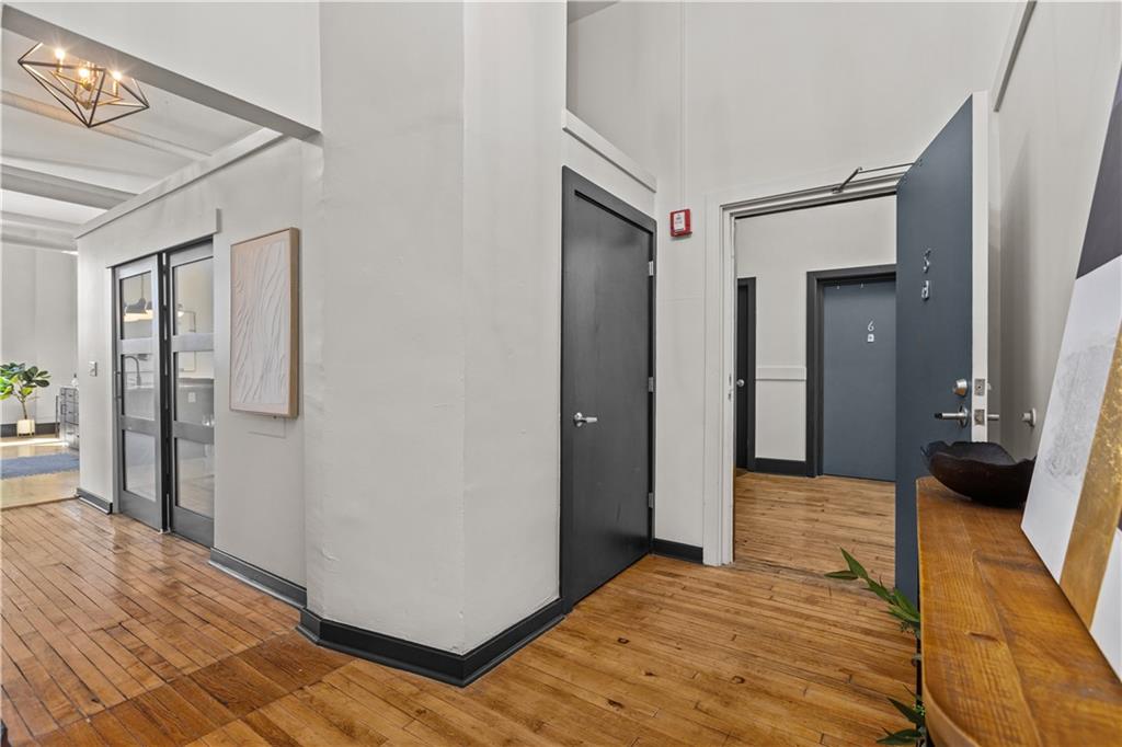 3080 Smallman Street, Unit 8 Pittsburgh, PA 15201 - Photo 10 of 39 a view of a hallway with wooden floor and cabinet