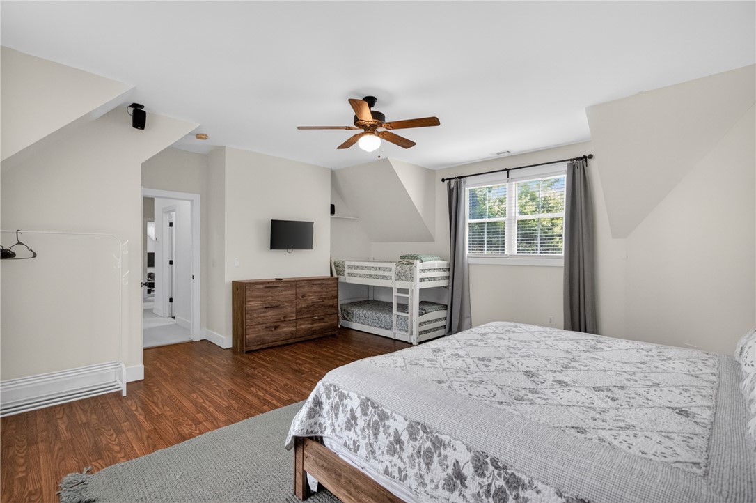 1504 Double Springs Road Townville, SC 29689 - Photo 34 of 41 This spacious bedroom features warm hardwood floors and abundant natural light, offering a comfortable living space.