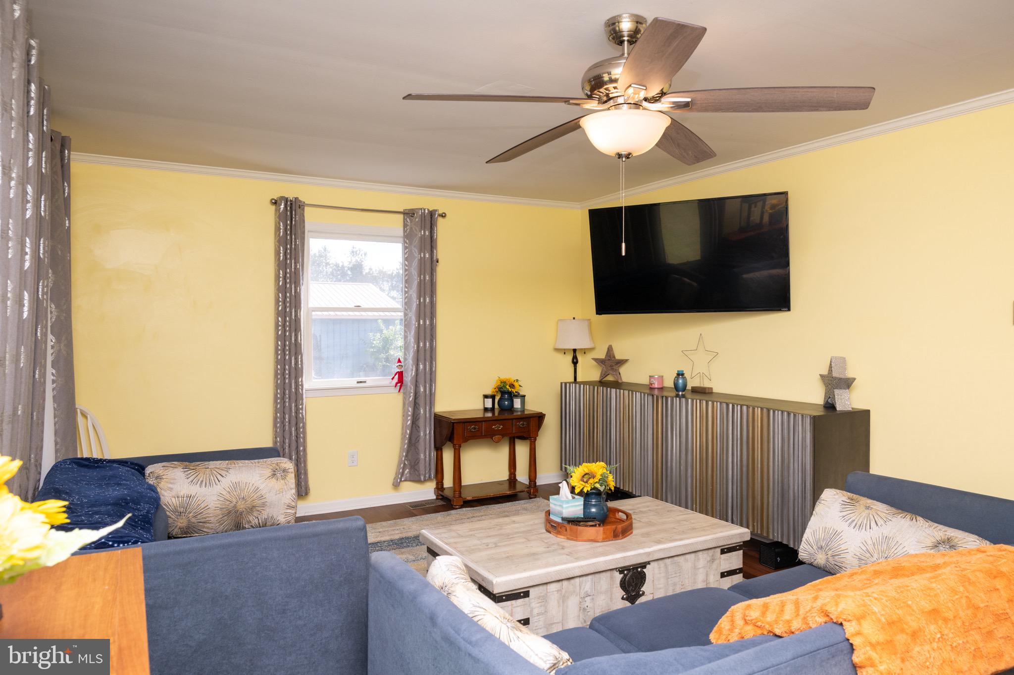 22400 Zoar Road Georgetown, DE 19947 - Photo 13 of 32 a living room with furniture and a flat screen tv