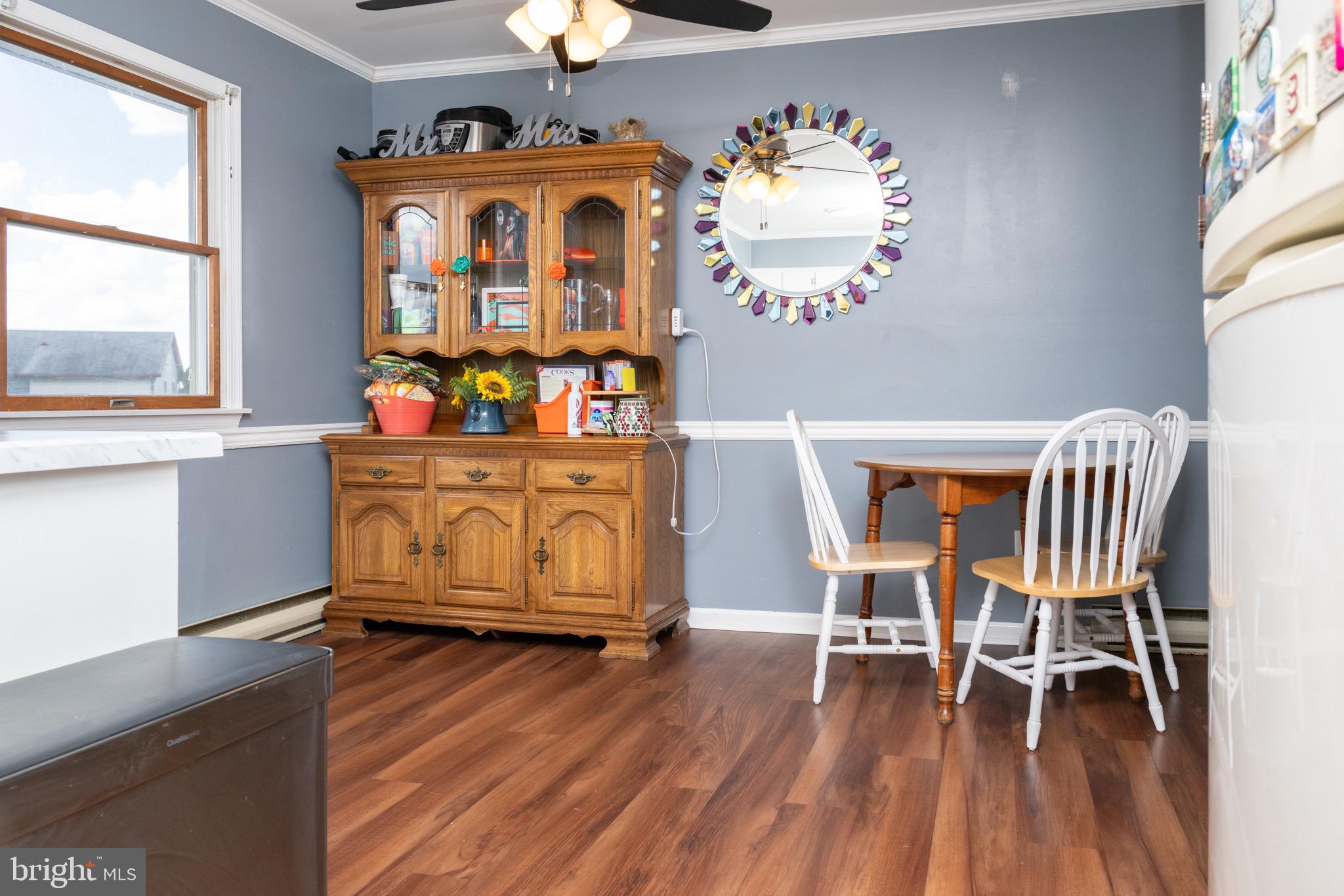 22400 Zoar Road Georgetown, DE 19947 - Photo 18 of 32 a view of a dining room with furniture window and wooden floor