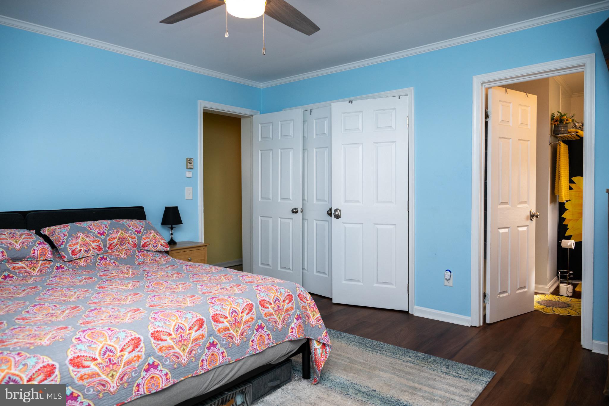 22400 Zoar Road Georgetown, DE 19947 - Photo 27 of 32 a bedroom with a bed and a chandelier