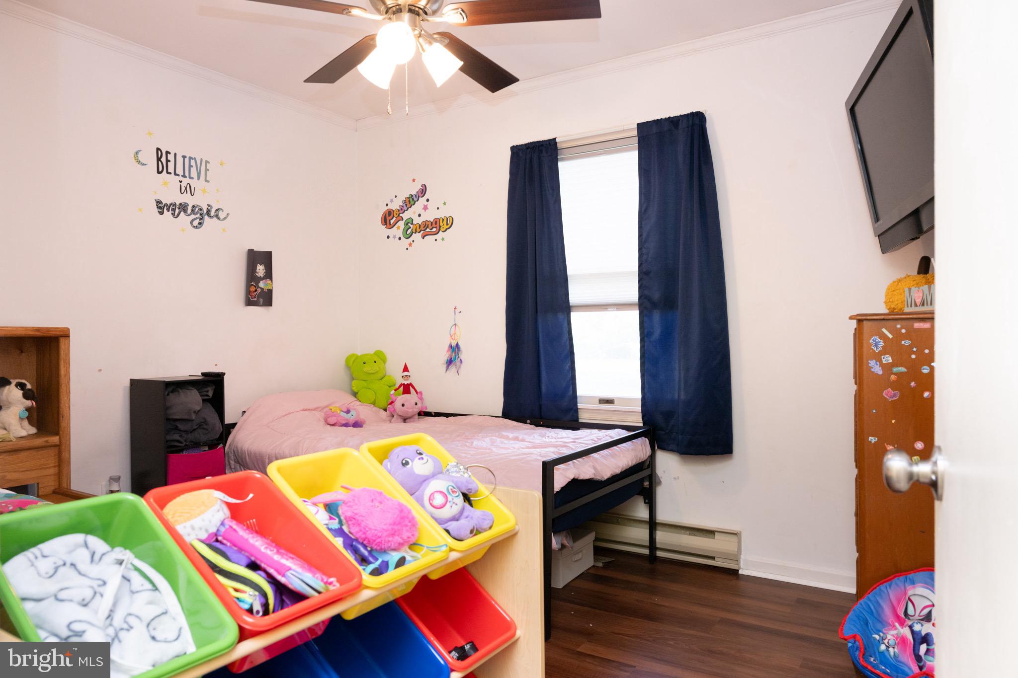 22400 Zoar Road Georgetown, DE 19947 - Photo 30 of 32 a bedroom with a bed and wooden floor
