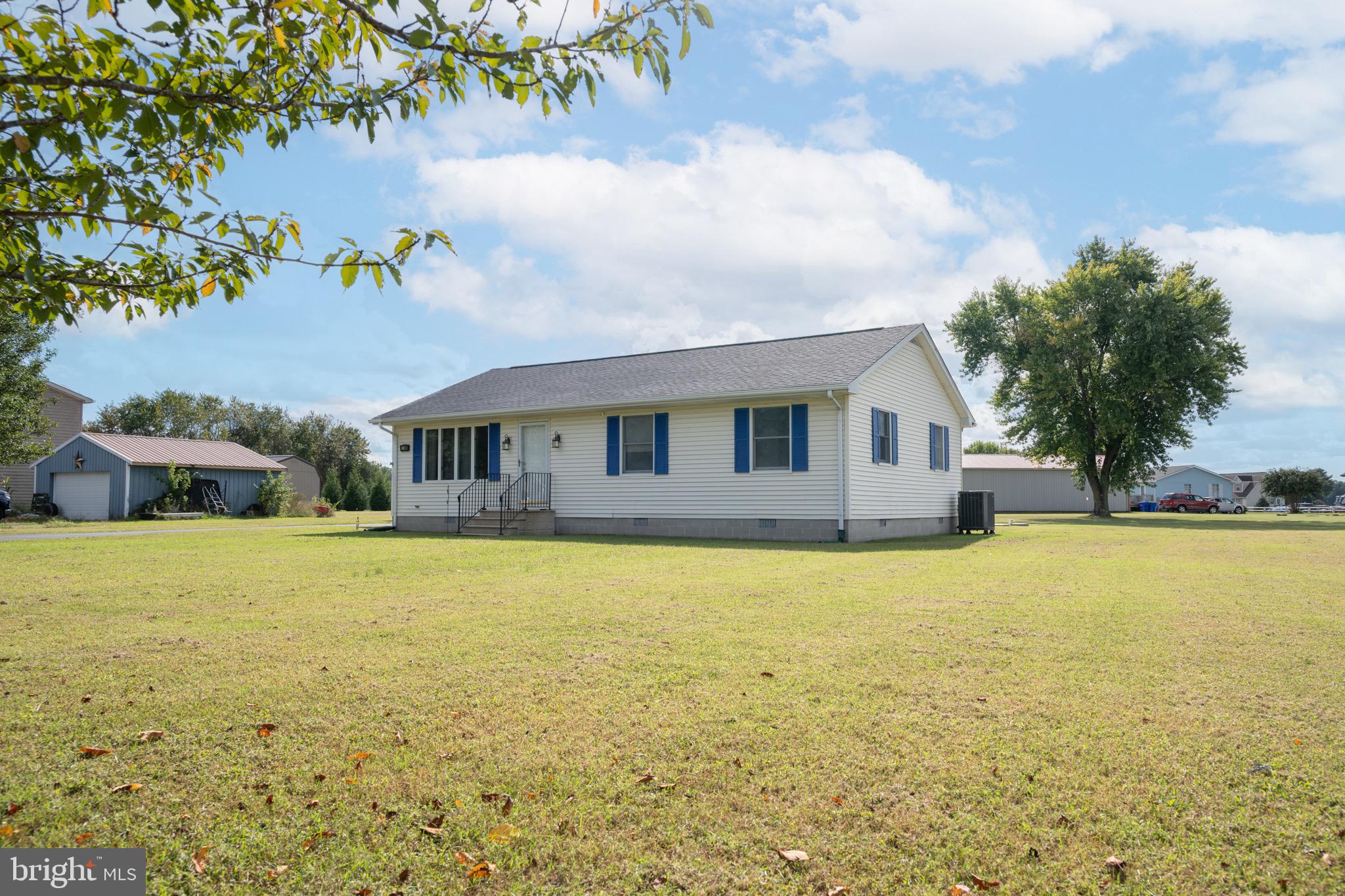 22400 Zoar Road Georgetown, DE 19947 - Photo 3 of 32 a front view of house with yard and trees in the background