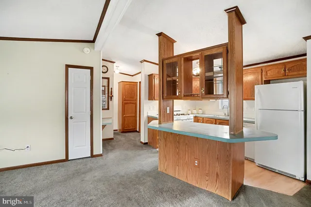 a kitchen with kitchen island granite countertop a sink and cabinets