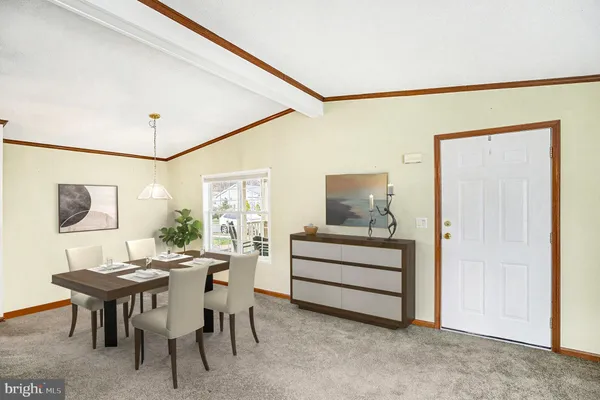 a view of a dining room with furniture and chandelier