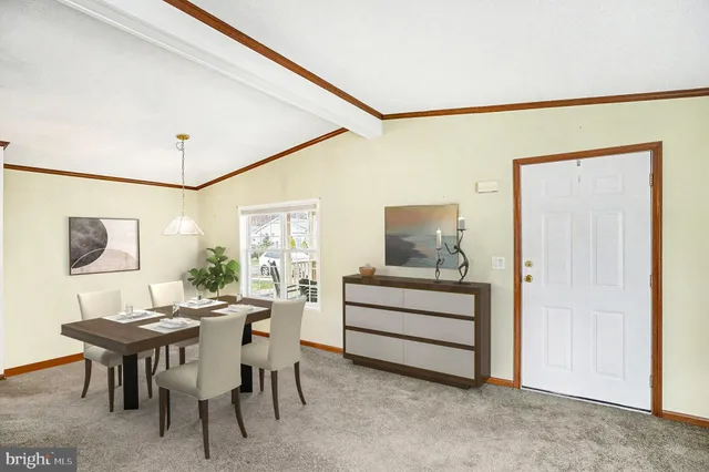 a view of a dining room with furniture and chandelier