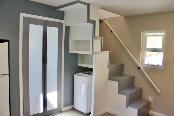a view of entryway and hall with wooden floor