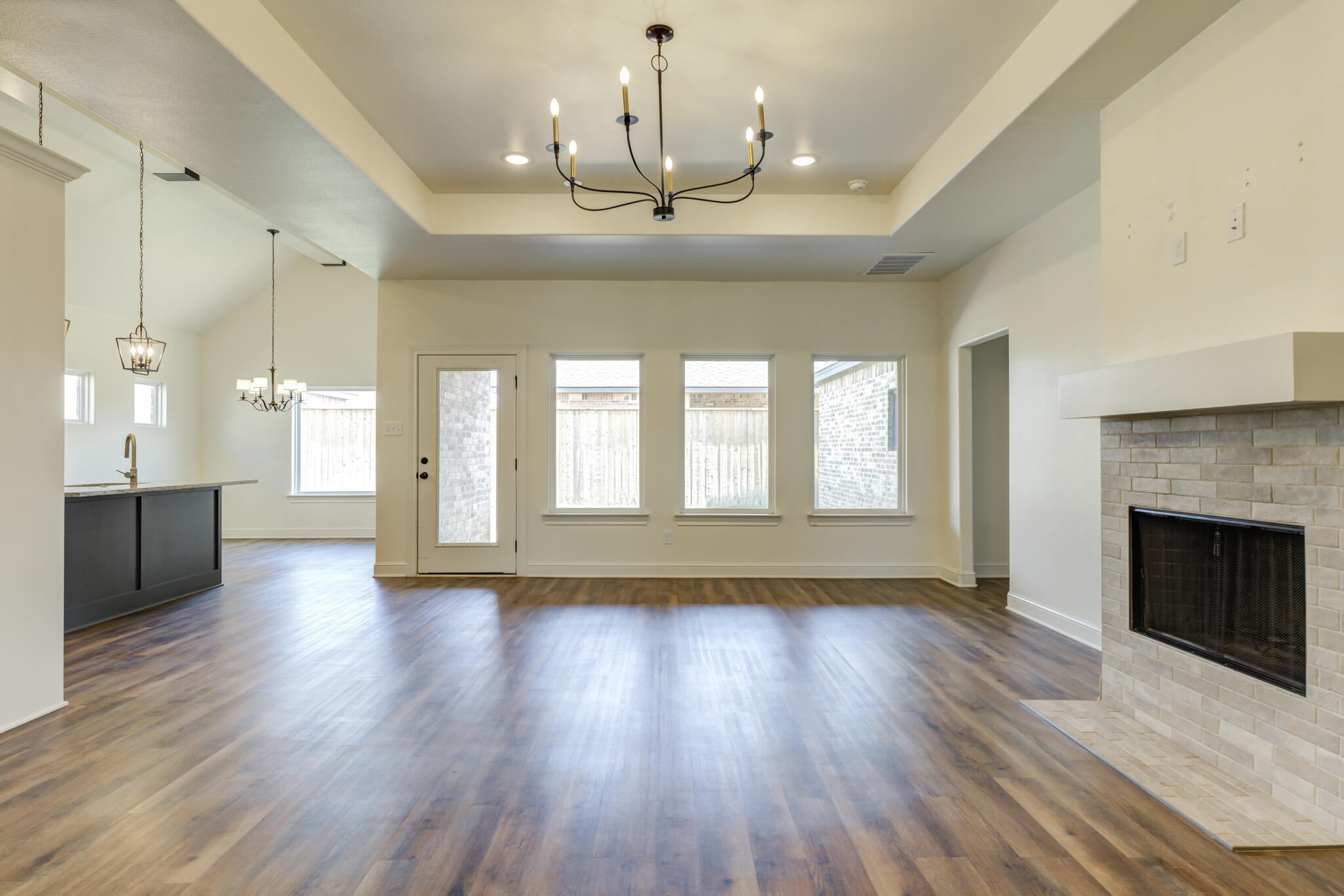 6908 55th Street Lubbock, TX 79407 - Photo 30 of 42 a view of an empty room with wooden floor and a fireplace