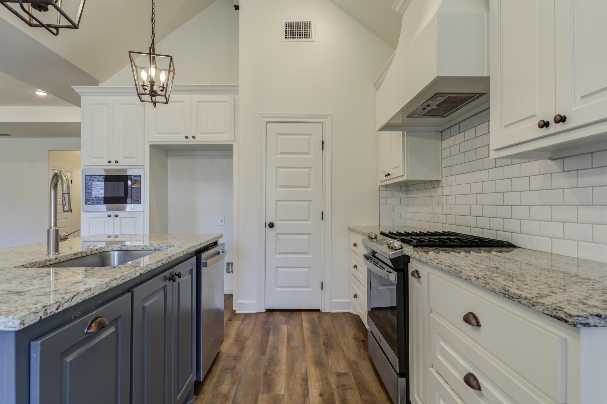6908 55th Street Lubbock, TX 79407 - Photo 36 of 42 a kitchen with granite countertop a sink stainless steel appliances and cabinets