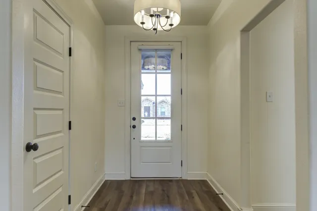 a view of an entryway with wooden floor