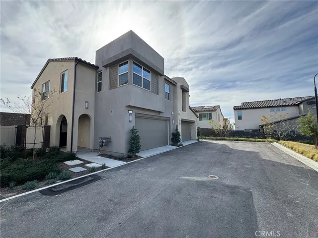 a backyard of a house with barbeque oven table and chairs