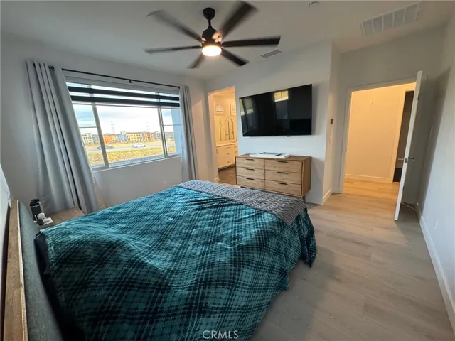 a bedroom with furniture and a wooden floor