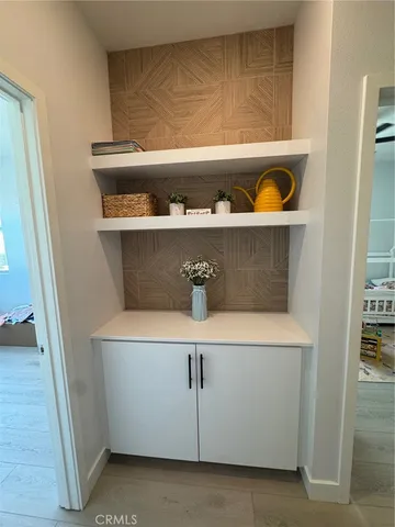 a view of a hallway with wooden floor and stairs